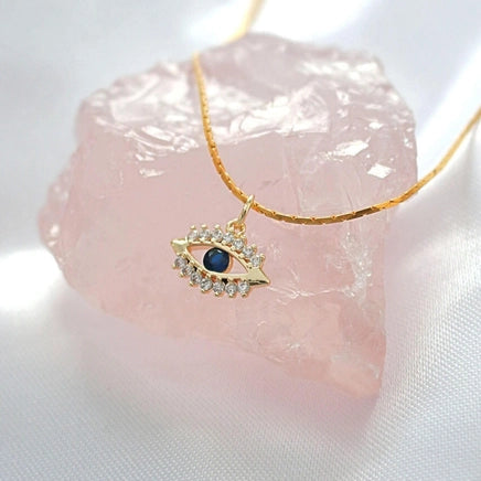 Goldene Evil Eye Halskette mit blauen und farblosen Zirkonia.