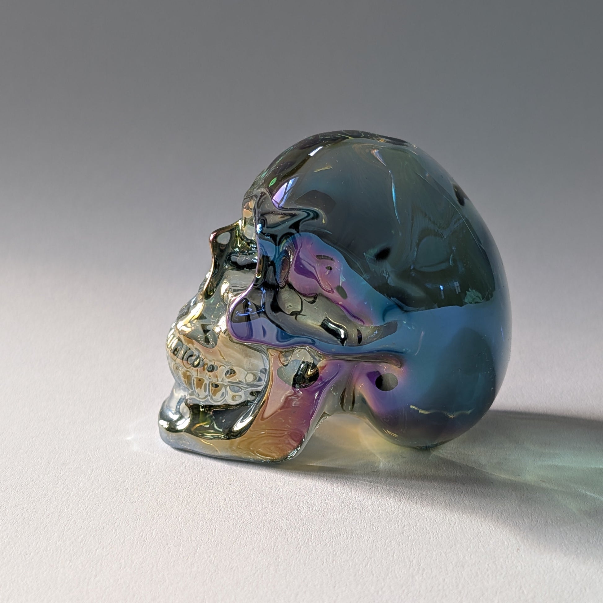 Kristallschädel "Trokan" (298g) aus Quarz mit schillernder Rainbow-Aurora Beschichtung.