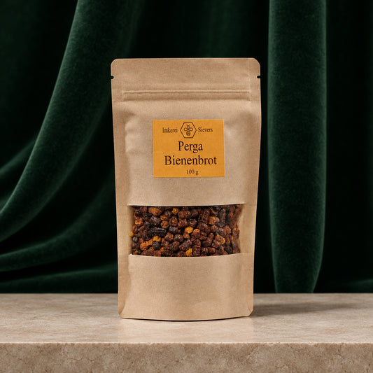 Perga Bienenbrot 100 g im Kraftpapierbeutel mit Sichtfenster vor dunkelgrünem Vorhang