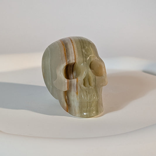 Handgeschnitzter Kristallschädel Kerwen aus grün-braunem Bänder-Aragonit (Grüner Onyx), 78 Gramm schwer, für emotionale Balance und Geduld.