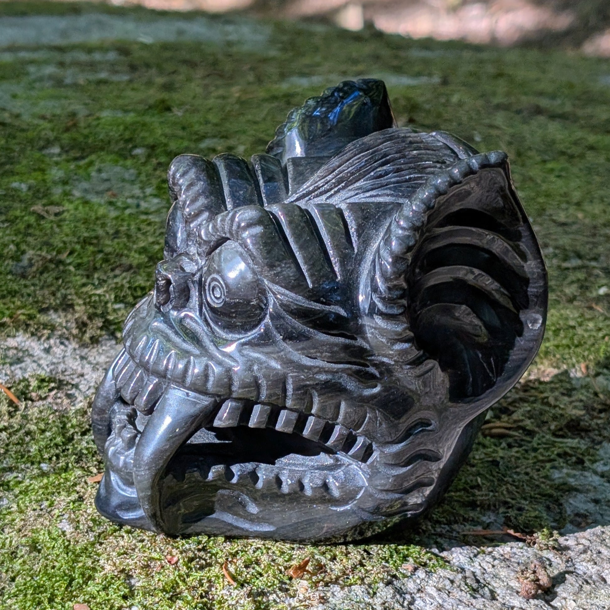 Kristallschädel "Dämonenwächter" aus tiefschwarzem Obsidian in Form einer mythischen Kreatur.