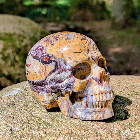 Kristallschädel "Wüstenwächter" aus Polychrom-Jaspis mit rötlicher und gelber Maserung.