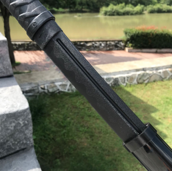 Schwarzes Polyurethan-Bokken im Freien vor einem See